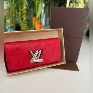 Louis Vuitton Red Twist wallet in Epi leather w/ a silver LV twist lock